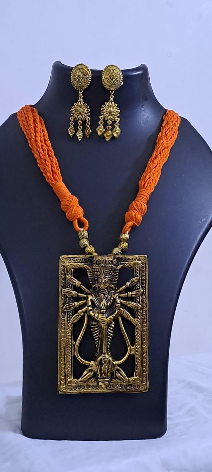 Orange thread necklace with oxidised golden durga pendant