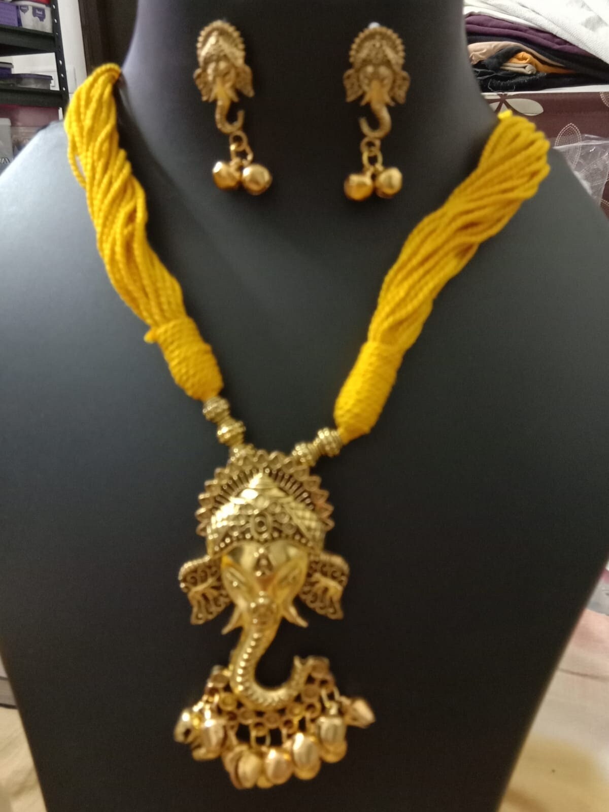Oxidised golden ganesha traditional pendant and matching earrings.