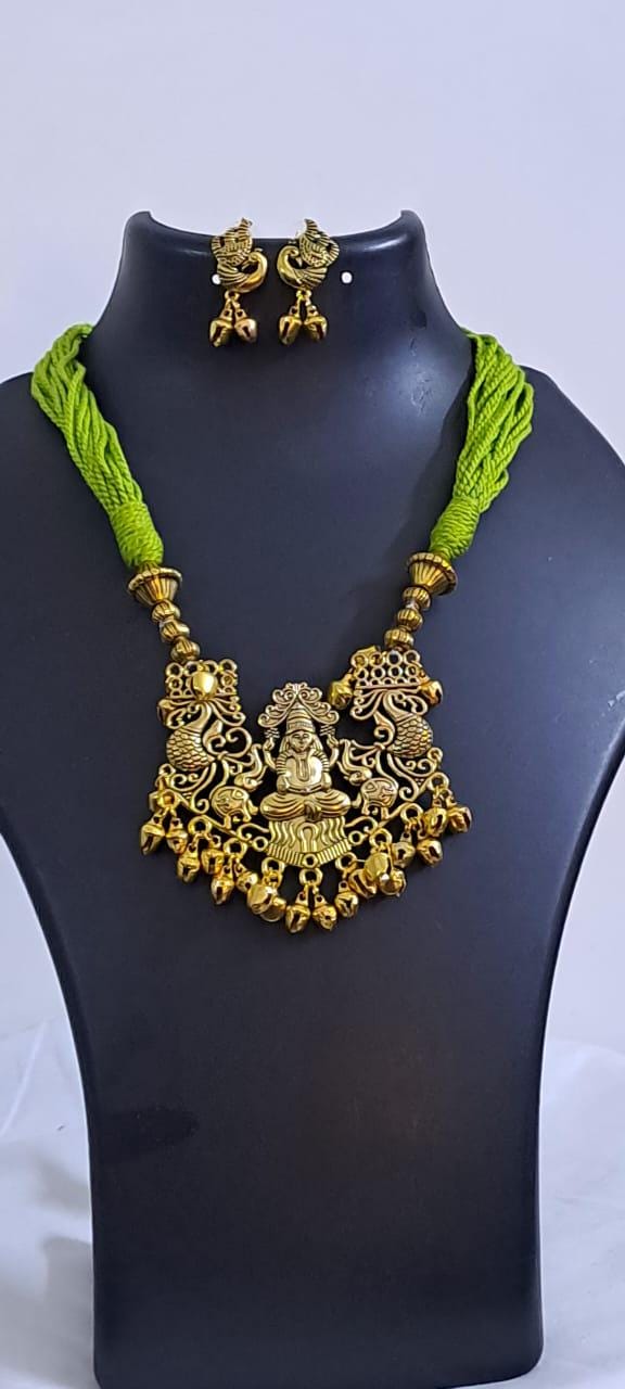 Light green thread necklace with Golden oxidised traditional pendant