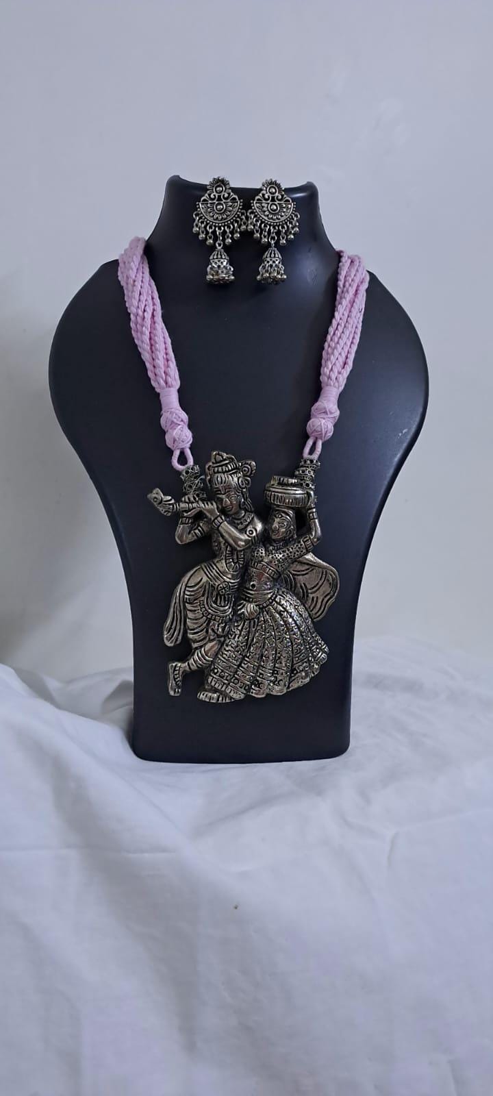 Radha Krishna silver oxidised pendant necklace in pink thread with matching earrings