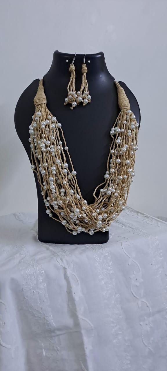 Multi layered jute necklace with pearl beads and with matching earrings.