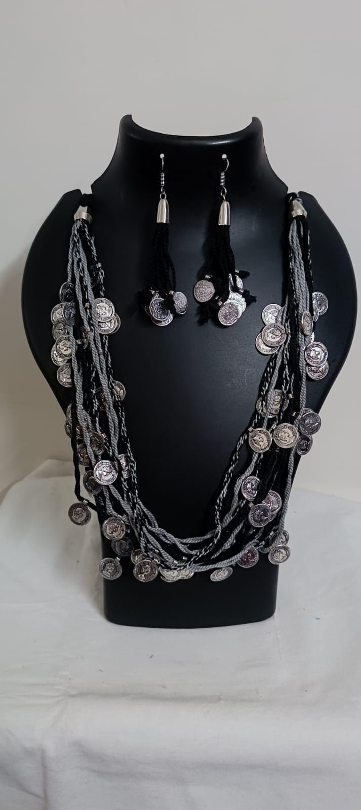 Exclusive multi-coloured and multi-layered thread necklace with silver oxidised charms