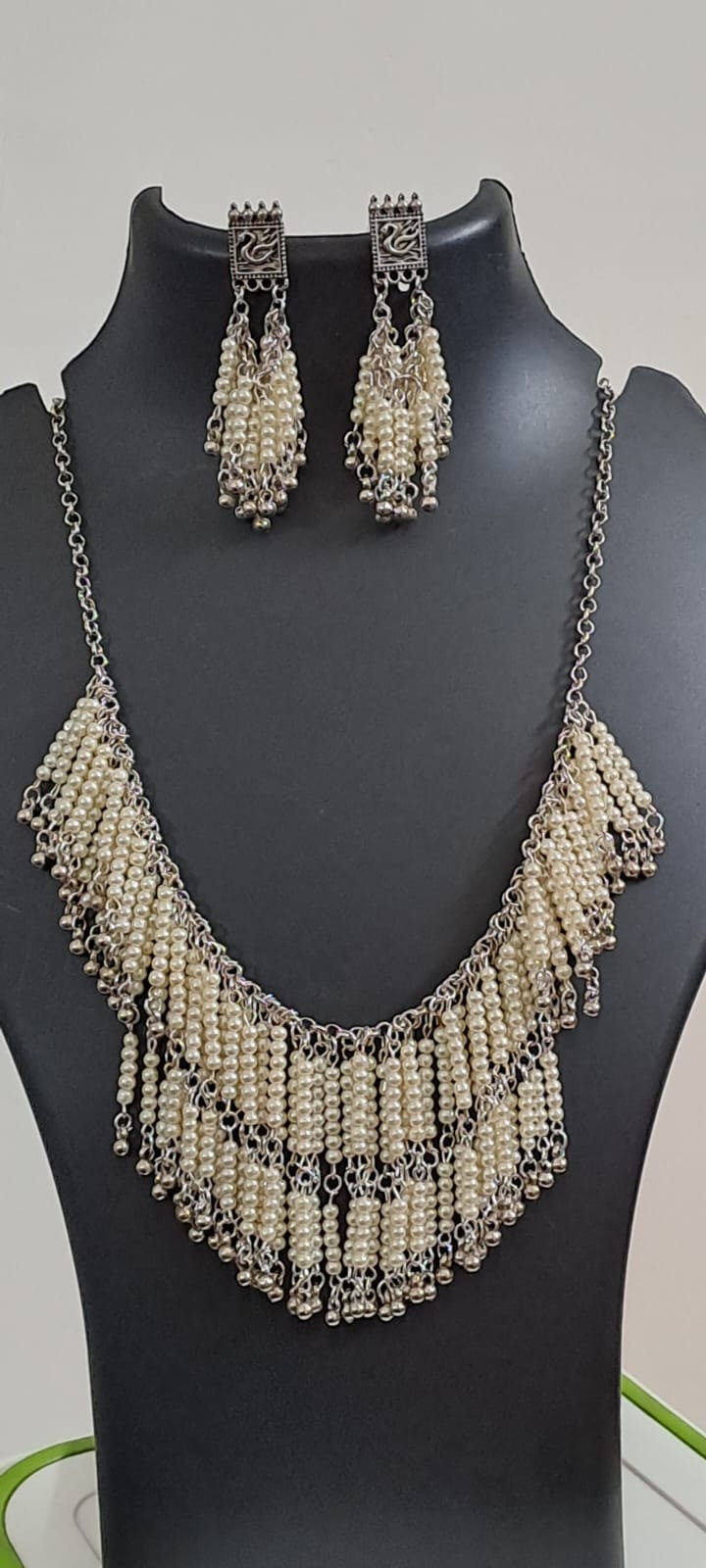 Exclusive layered off white seed beads necklace with matching hanging earrings.