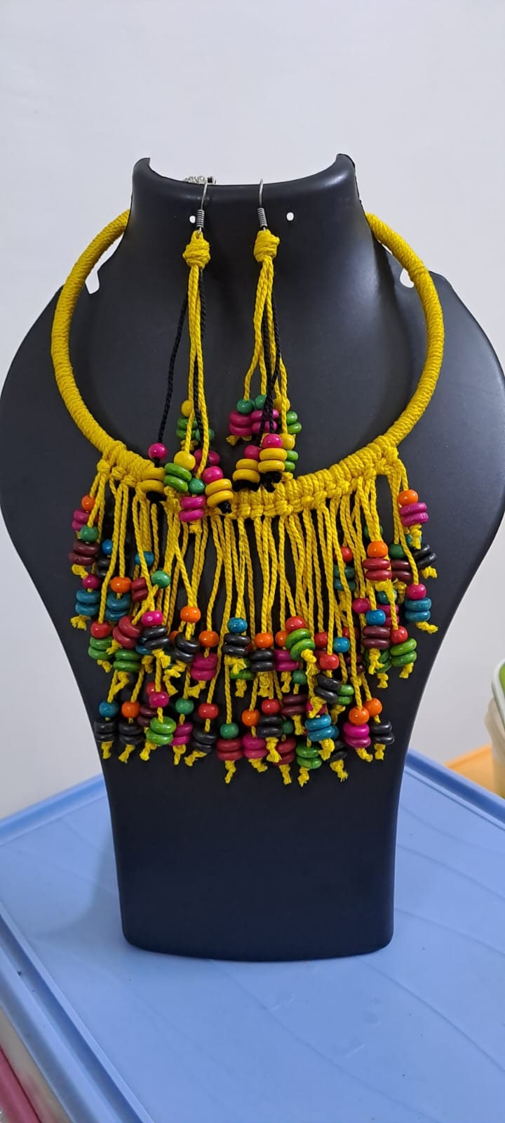 Exclusive yellow thread neckband with fringes and matching earrings.