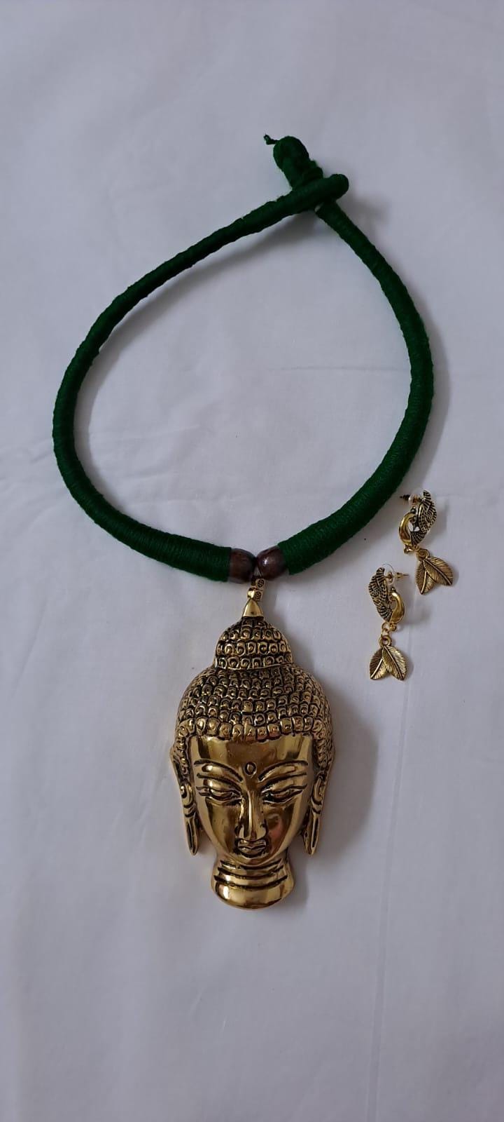 Green thread necklace with oxidised golden buddha pendant