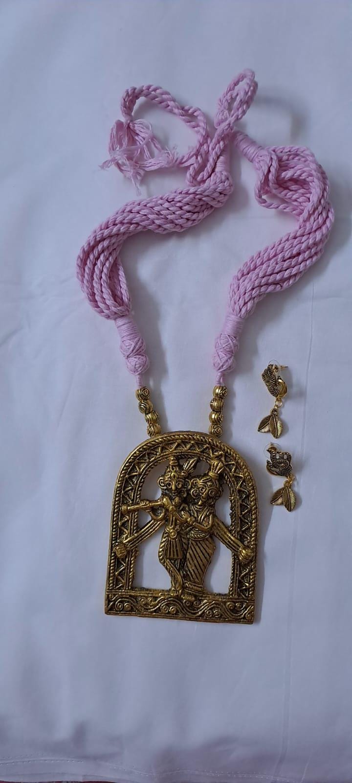 Radha Krishna golden oxidised pendant necklace in pink tread with matching earrings