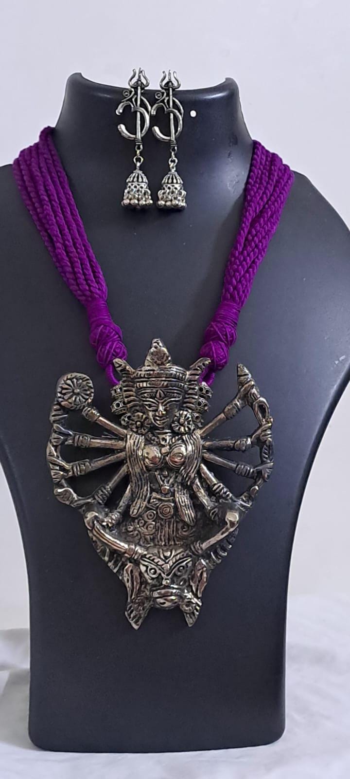 purple thread necklace with oxidised golden durga pendant