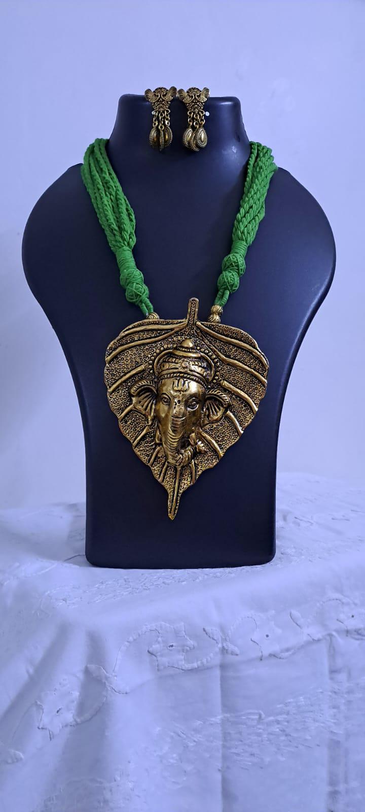 Green thread necklace with golden oxidised ganesha pendant