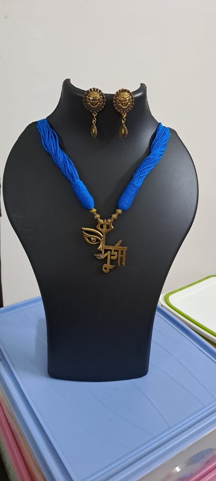 Blue thread necklace with oxidised golden durga pendant