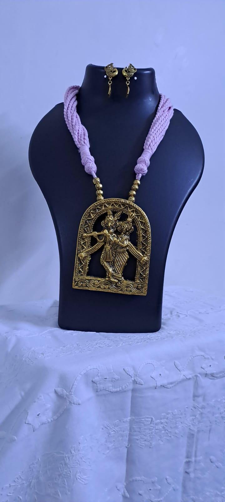 Radha Krishna golden oxidised pendant necklace in pink tread with matching earrings