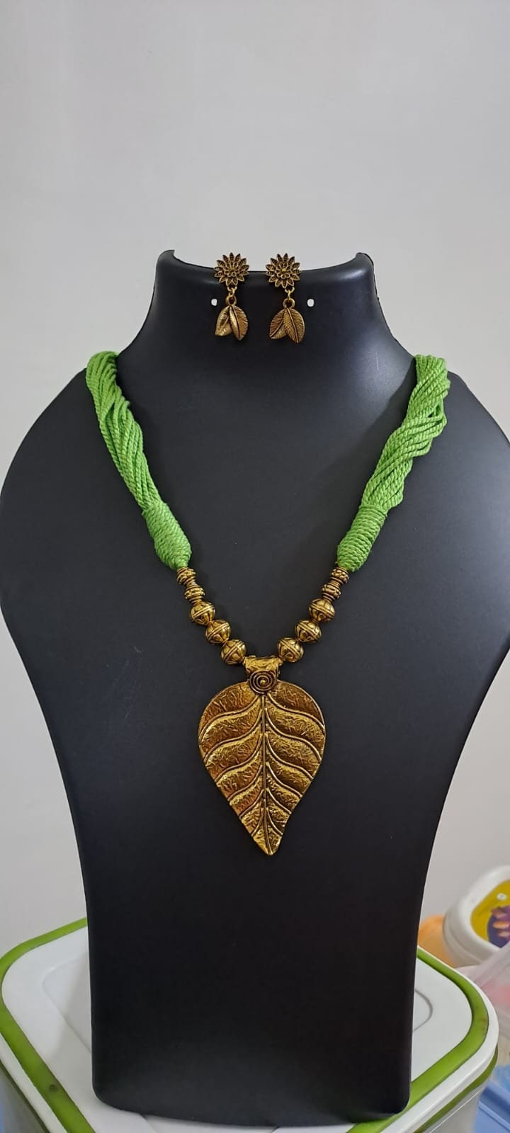 Green thread necklace with golden oxidised golden leaf traditional pendant