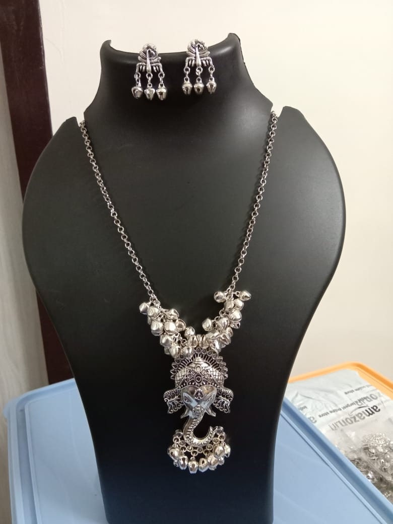 Oxidised silver chain with traditional pendant and matching earrings.