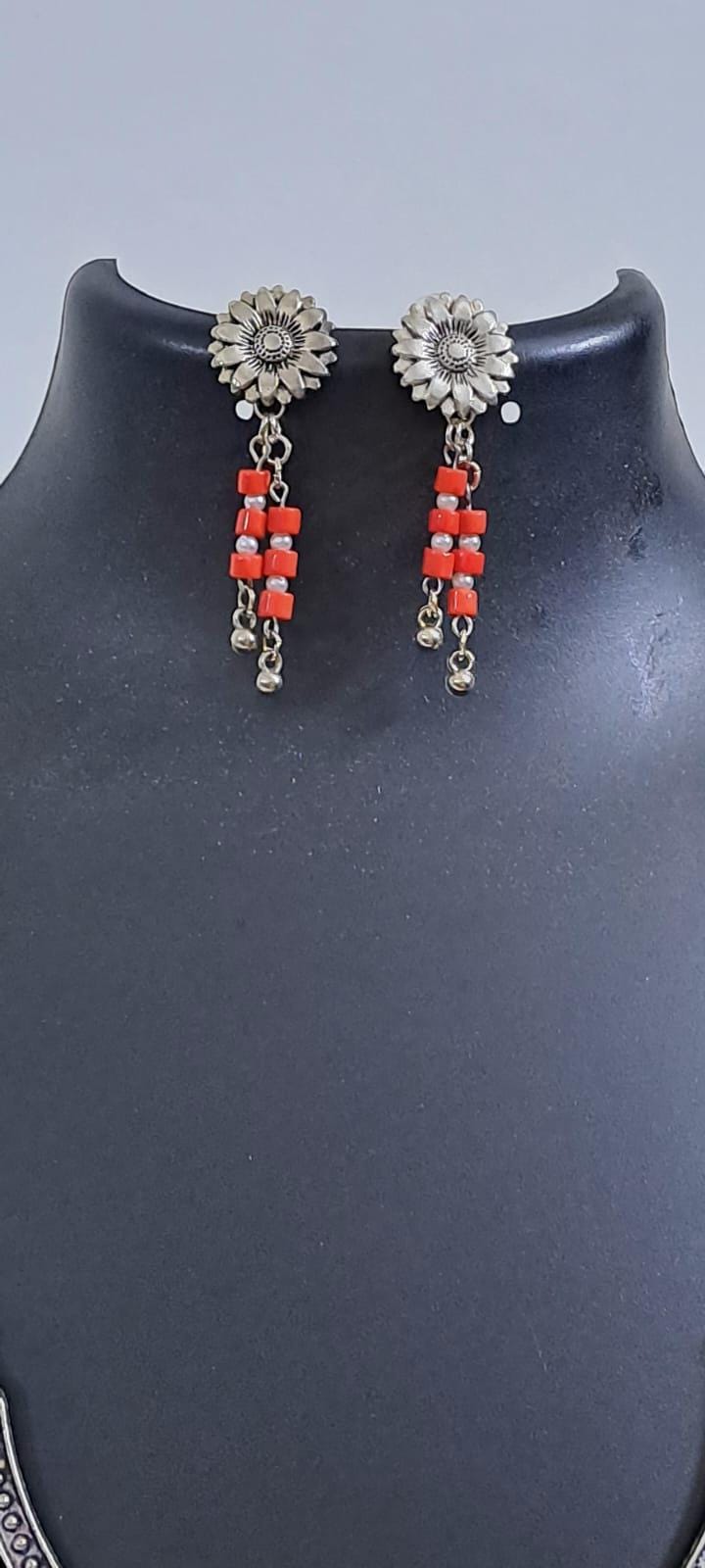 Exclusive necklace with silver oxidised big oval pendant with glass beads fringes and matching earrings.