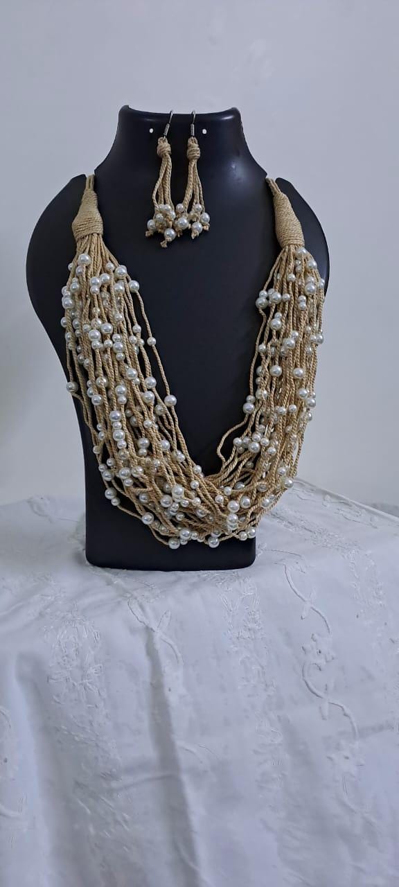 Multi layered jute necklace with pearl beads and with matching earrings.