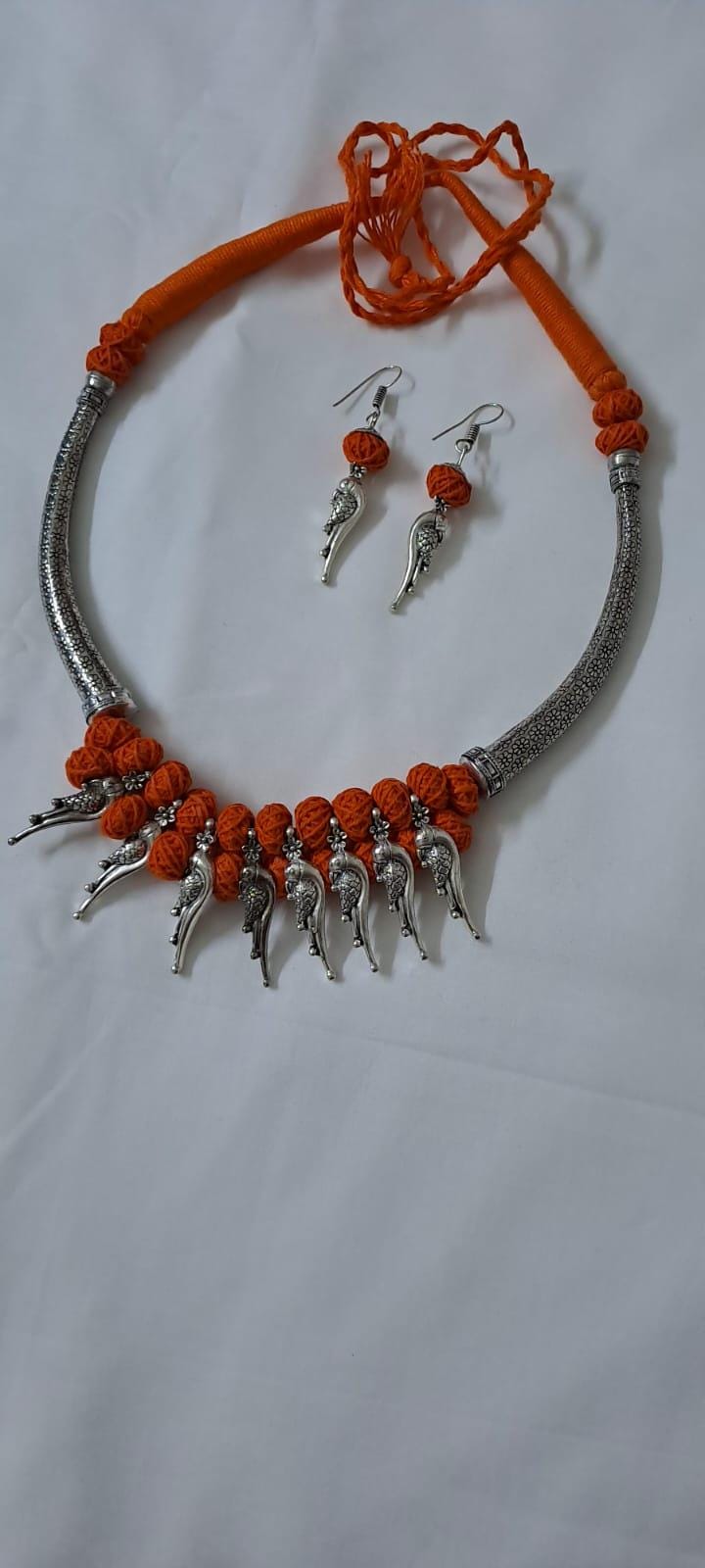 Orange thread necklace with kolhapuri silver oxidised traditional beads and matching earrings