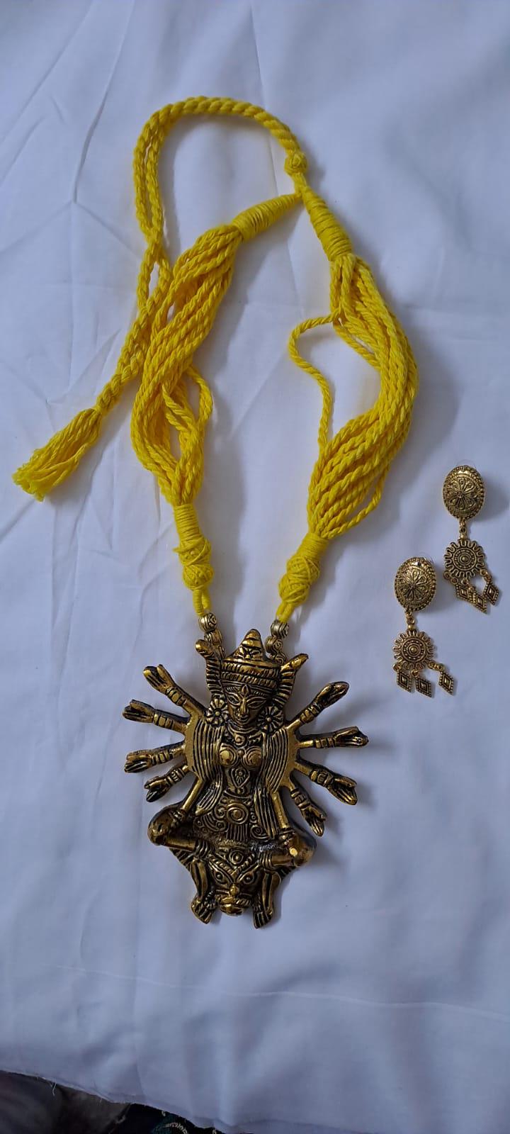 Yellow thread necklace with oxidised golden durga pendant