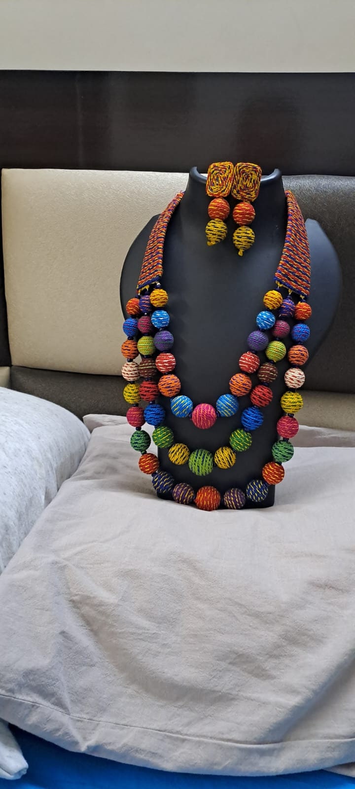 Multi layered and multicoloured necklace with colouful thread ball beads and with matching earrings.