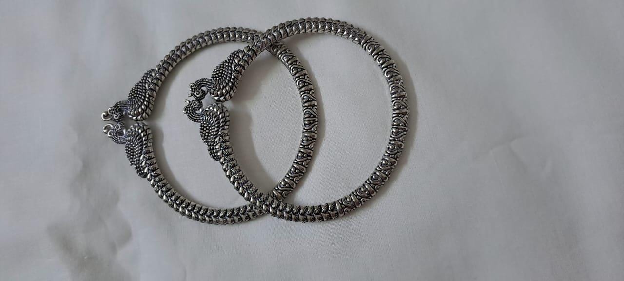 Traditional silver oxidised bangles with peacock
