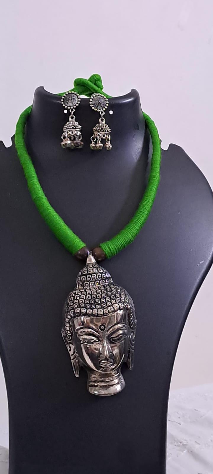 Green thread necklace with silver oxidised buddha pendant