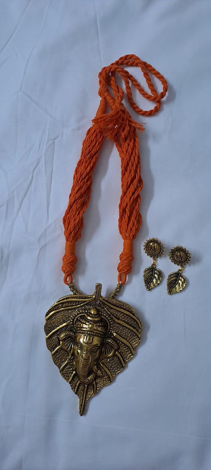 Orange thread necklace with golden oxidised ganesha pendant