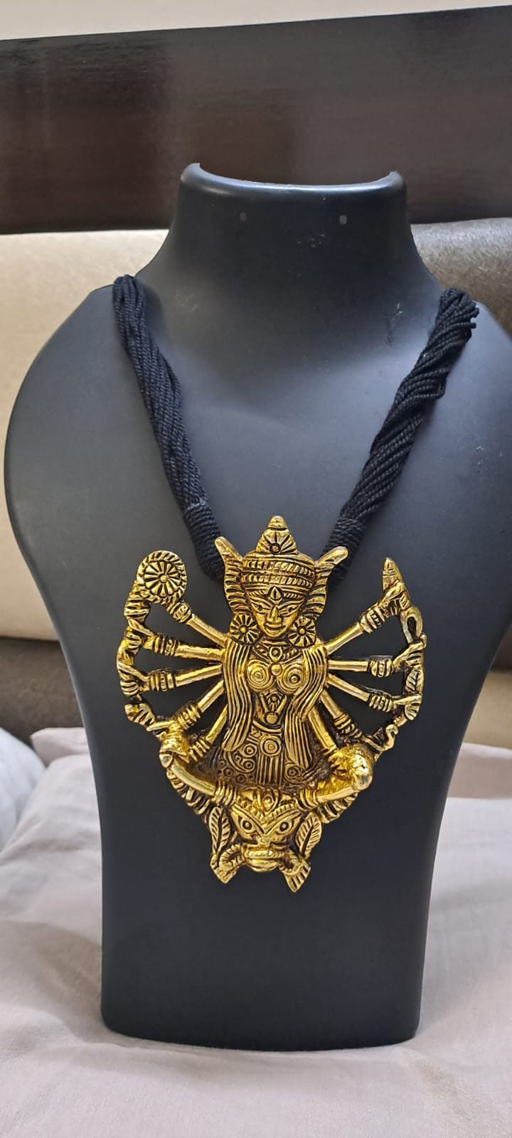 Black thread necklace with oxidised golden durga pendant