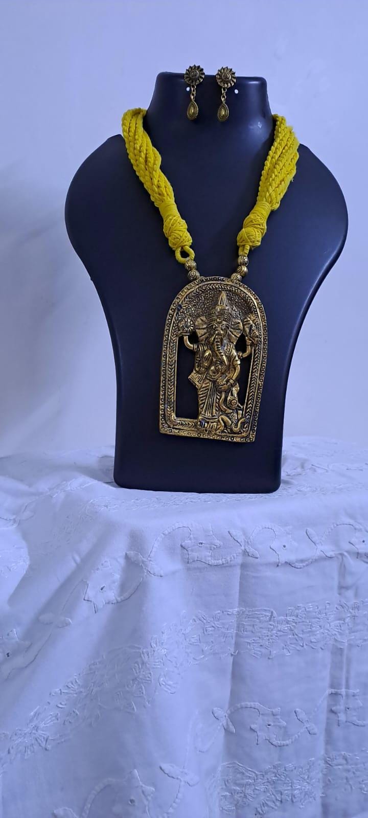 Yellow thread necklace with golden oxidised ganesha pendant