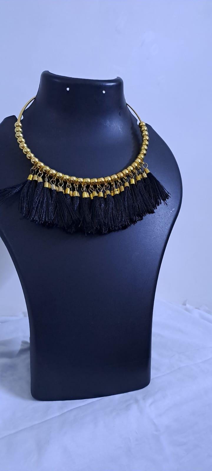 Golden neckband with black silk thread fringes and matching earrings