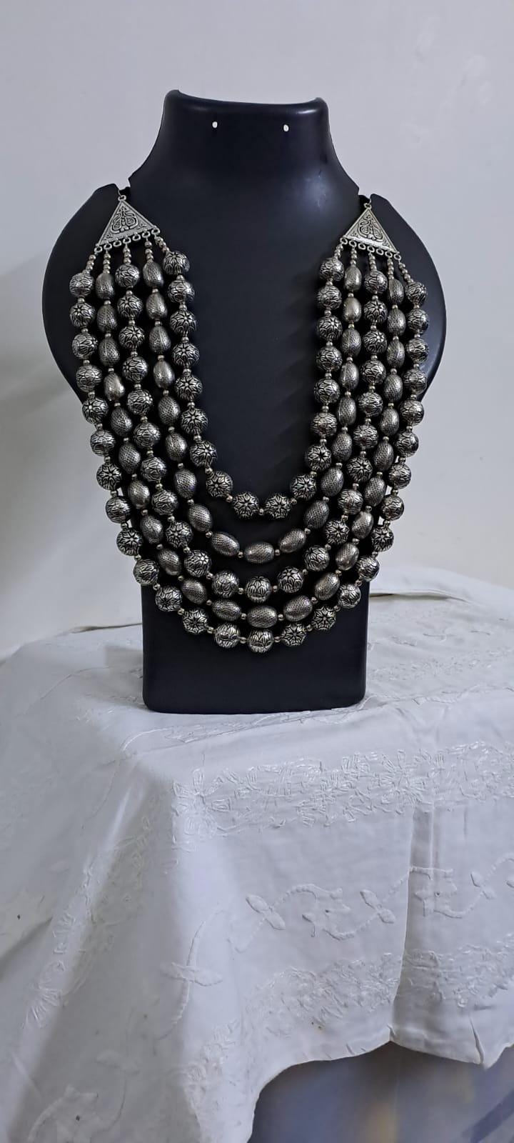 Multi-layered silver oxidised beads necklace .