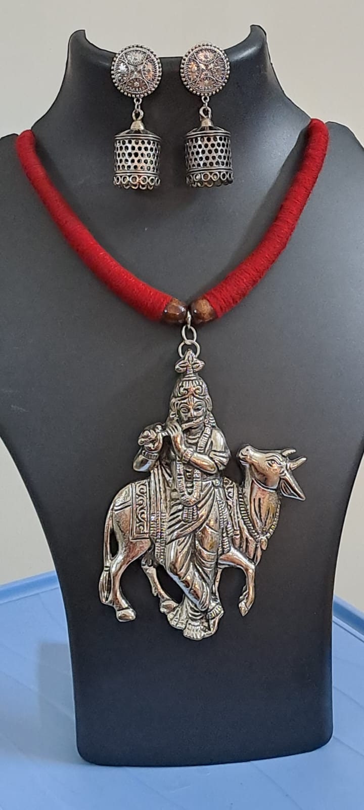 Red thread necklace with silver oxidised krishna pendant