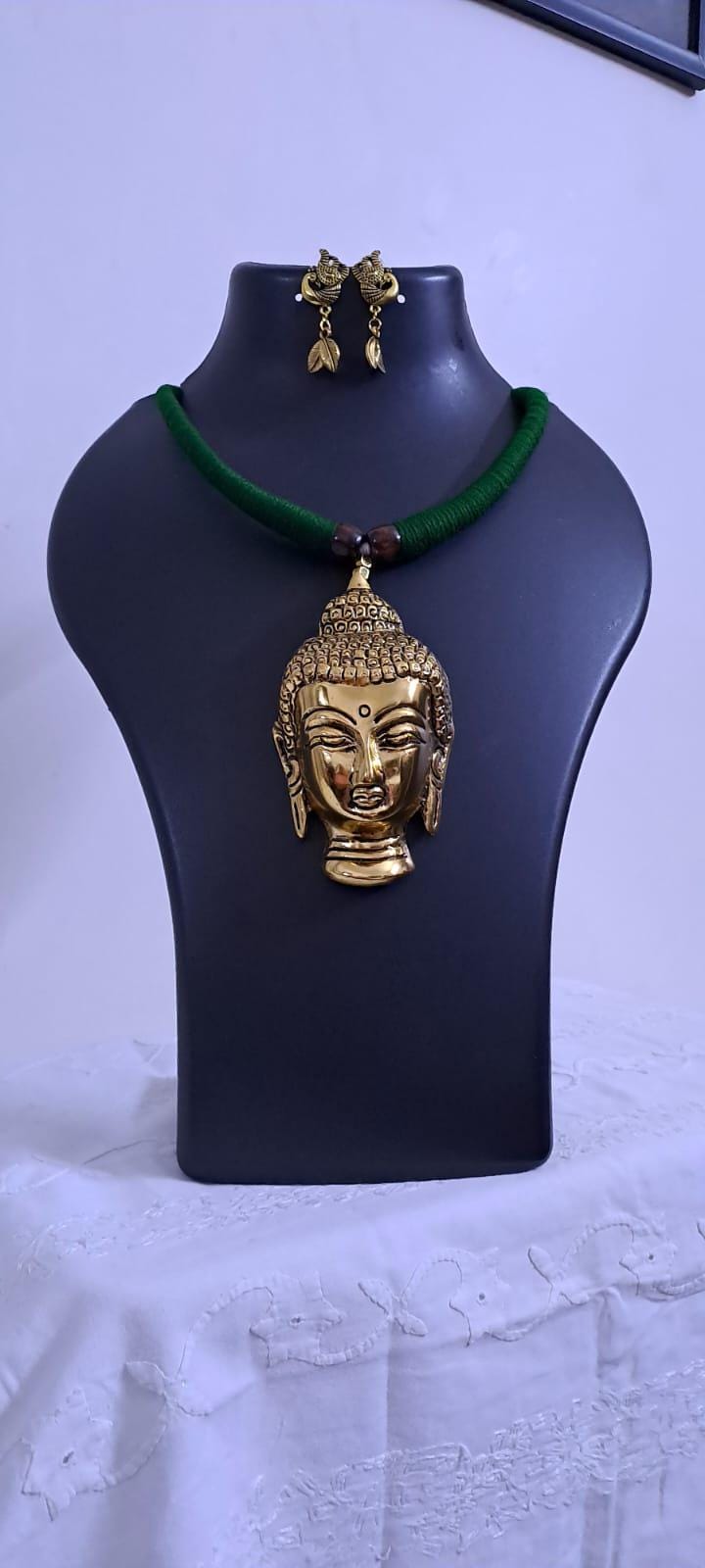 Green thread necklace with oxidised golden buddha pendant