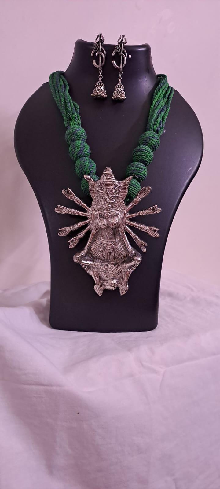Green thread necklace with oxidised golden durga pendant