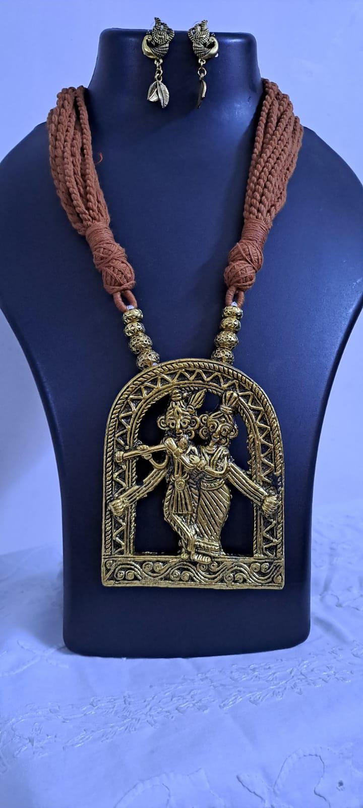 Radha Krishna golden oxidised pendant necklace in brown tread with matching earrings