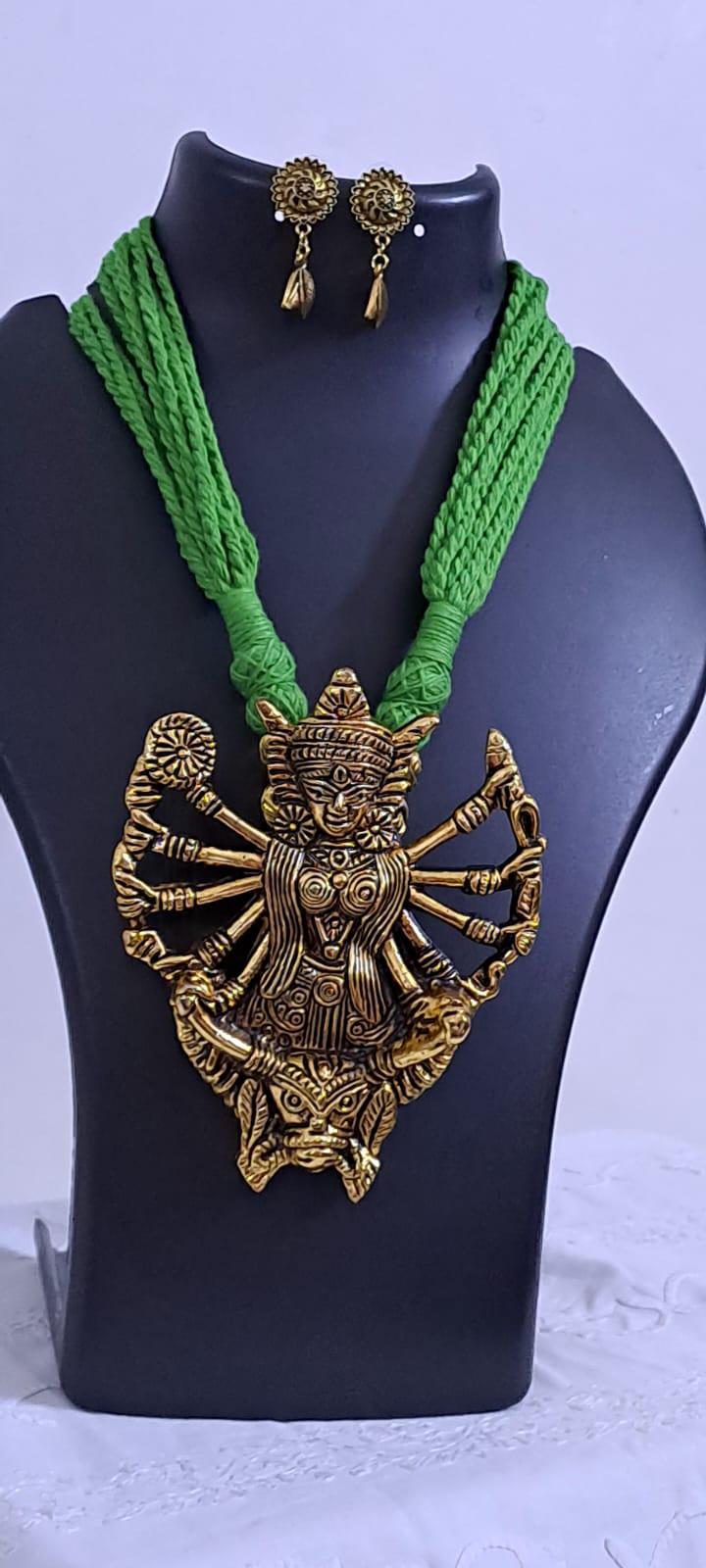 Green thread necklace with oxidised golden durga pendant