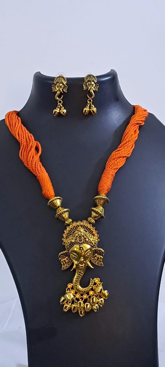 Orange thread necklace with Golden oxidised traditional pendant