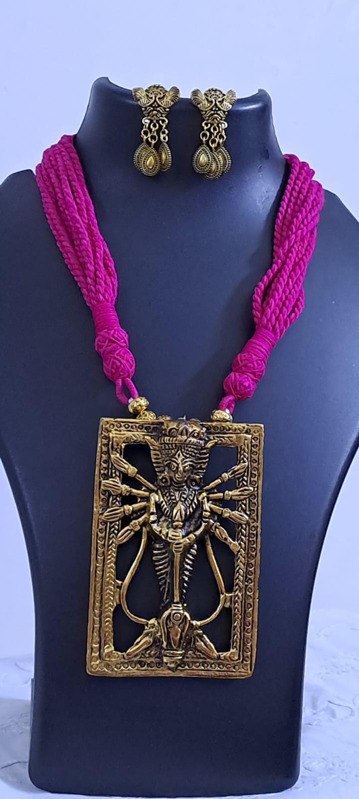 Pink thread necklace with oxidised golden durga pendant