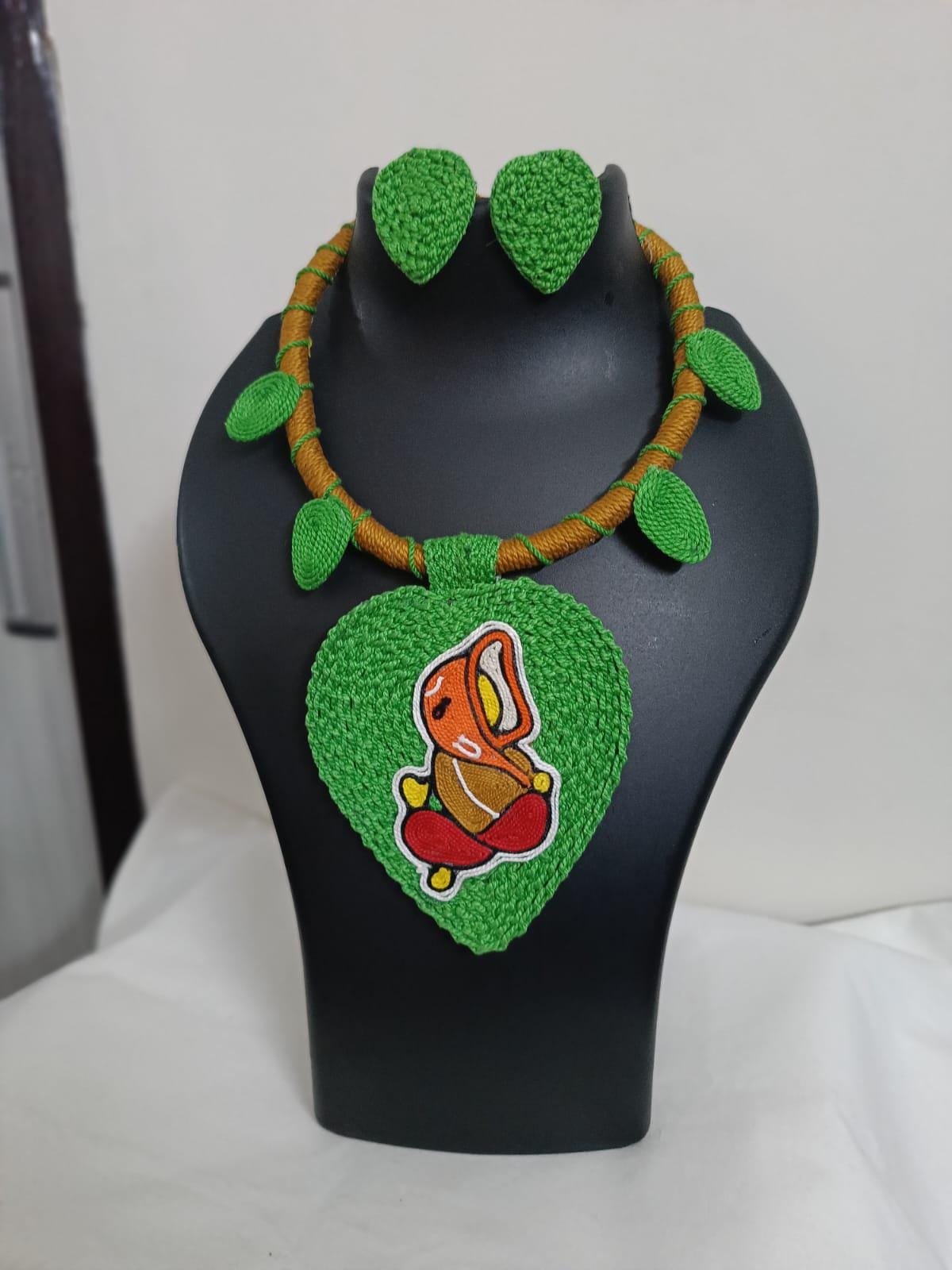 Exclusive light green and brown  thread necklace with leaf shaped  Ganesha pendant  and matching earrings.