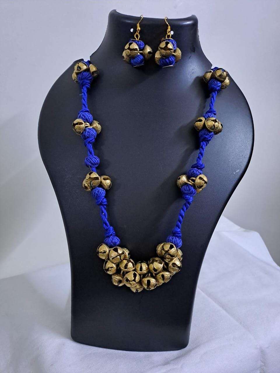Blue thread necklace with trinkets n matching earrings