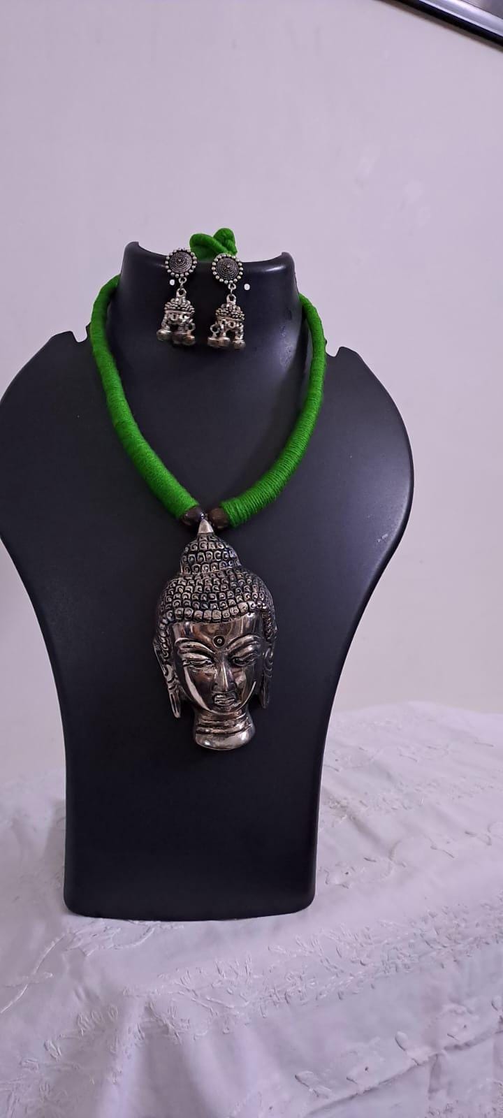 Green thread necklace with silver oxidised buddha pendant
