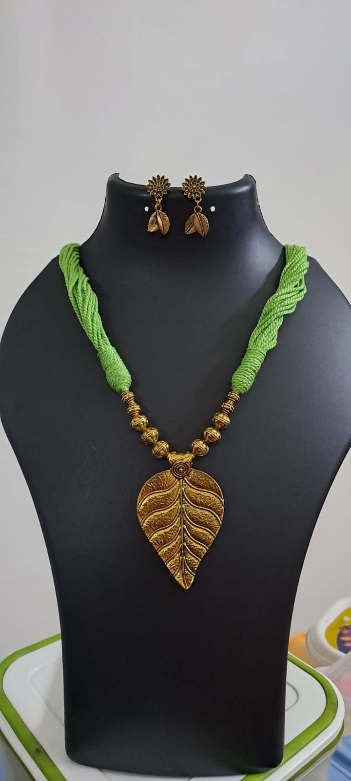 Green thread necklace with golden oxidised golden leaf traditional pendant