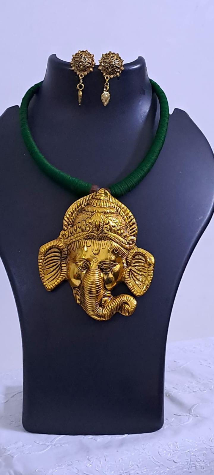 Green thread necklace with golden oxidised ganesha pendant