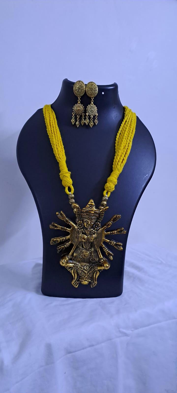 Yellow thread necklace with oxidised golden durga pendant