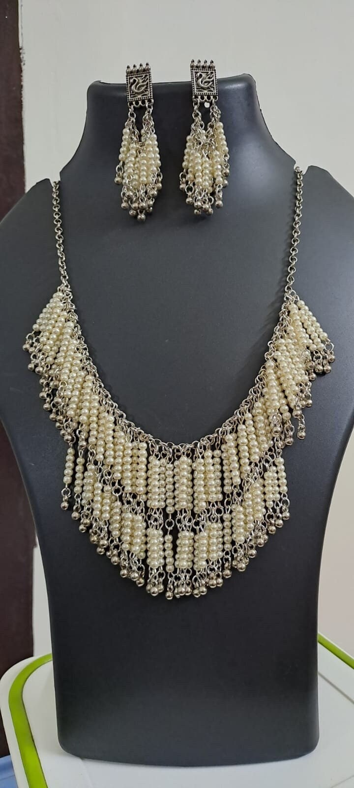 Exclusive layered off white seed beads necklace with matching hanging earrings.