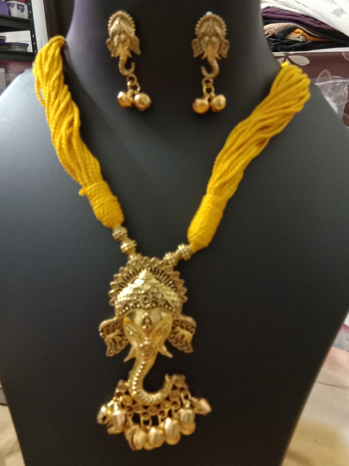 Oxidised golden ganesha traditional pendant and matching earrings.