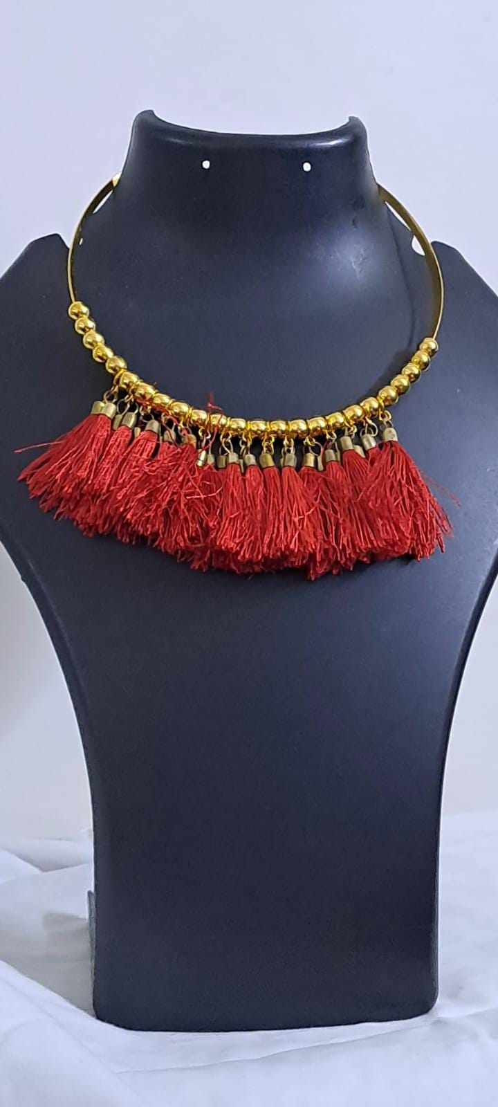 Golden neckband with red silk thread fringes and matching earrings