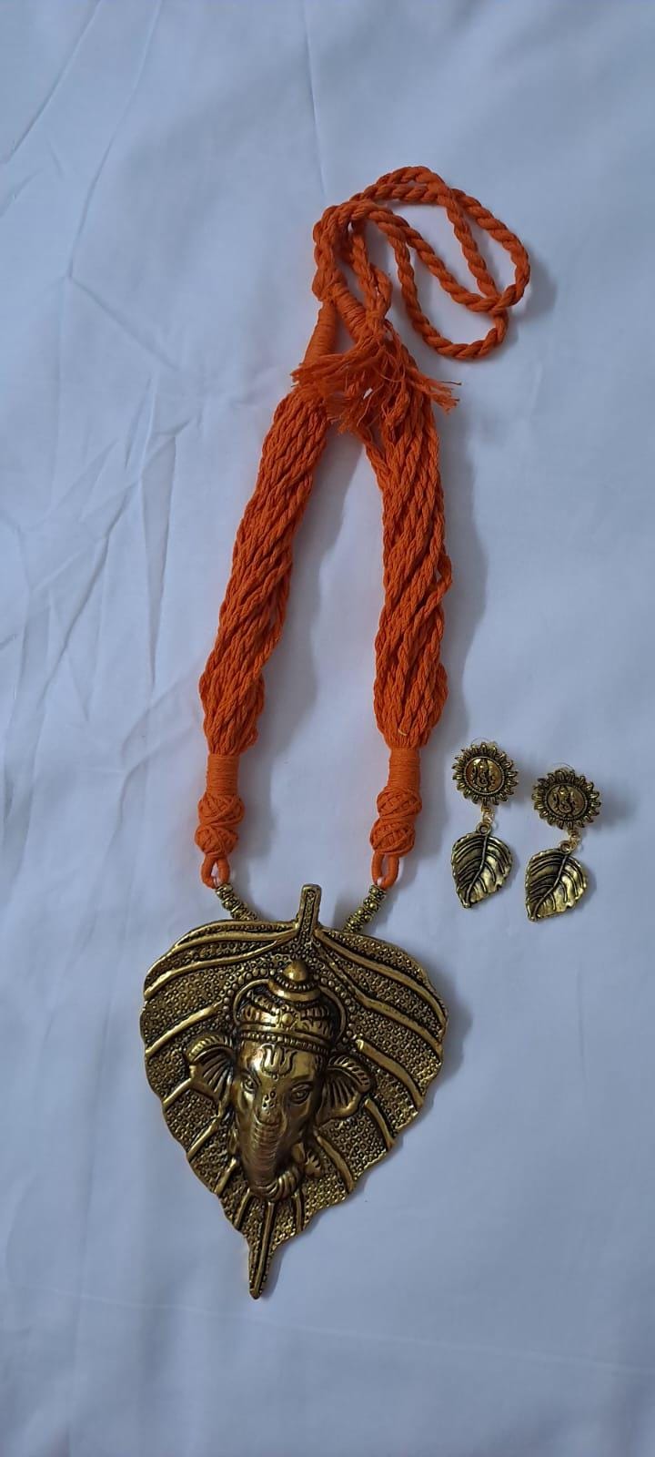 Orange thread necklace with golden oxidised ganesha pendant