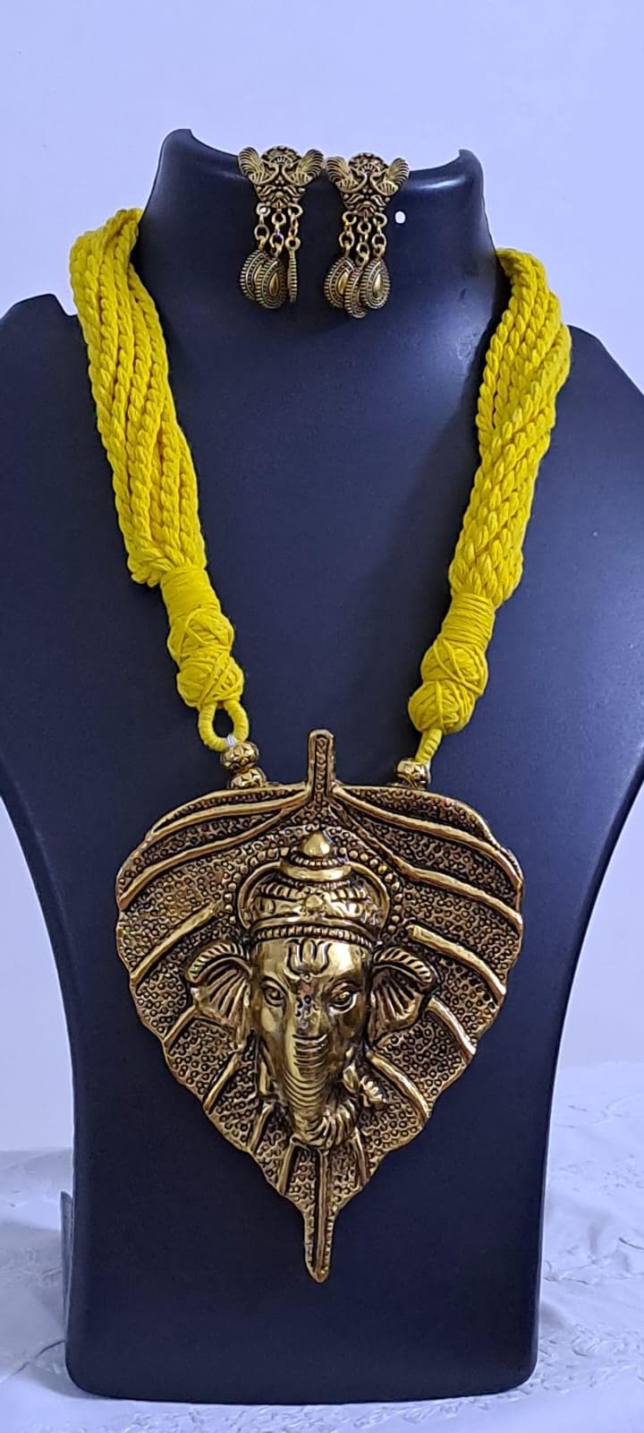 Yellow thread necklace with golden oxidised ganesha pendant
