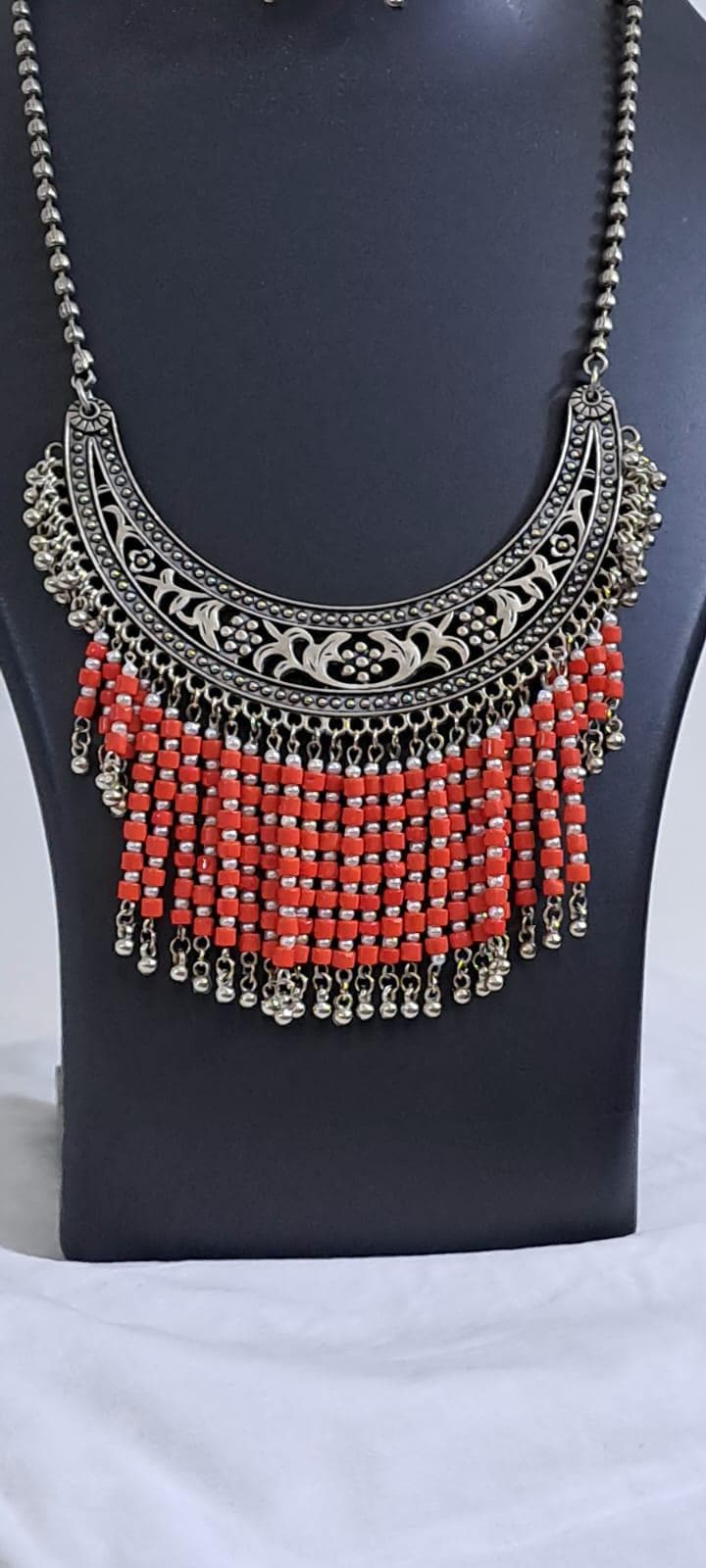 Exclusive necklace with silver oxidised big oval pendant with glass beads fringes and matching earrings.