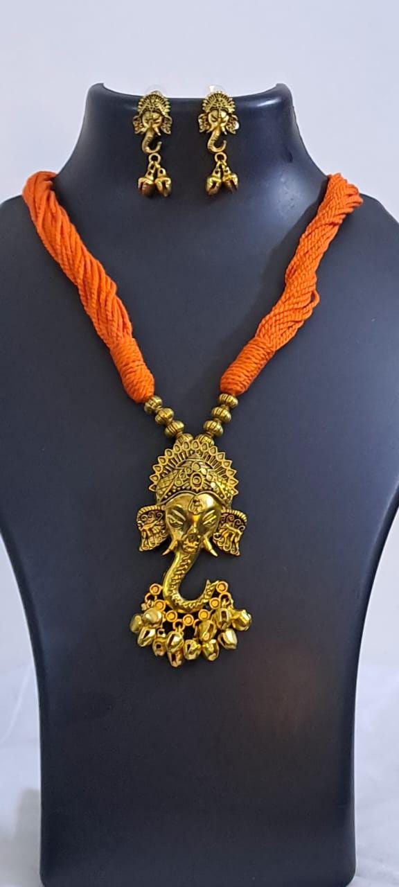 Orange thread necklace with Golden oxidised traditional pendant