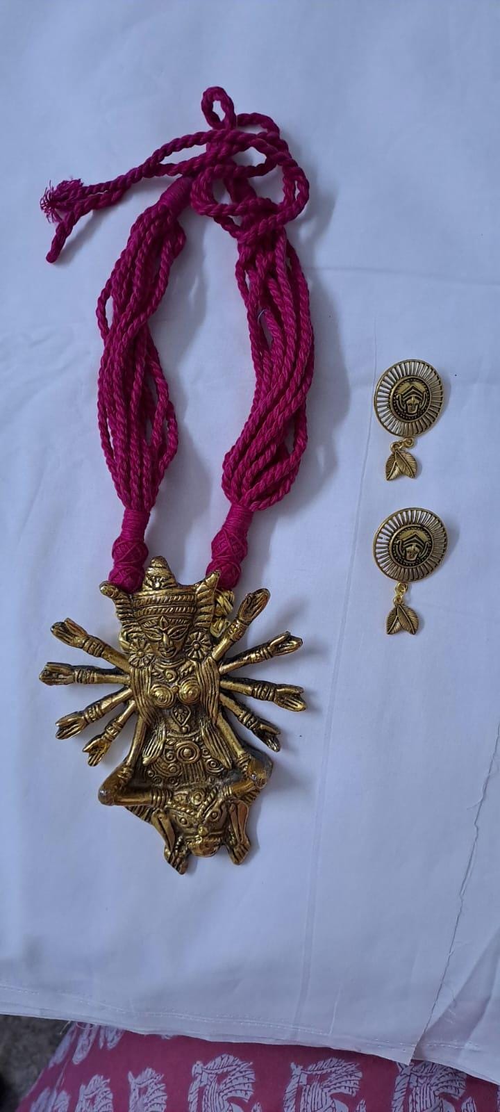 Pink thread necklace with oxidised golden durga pendant