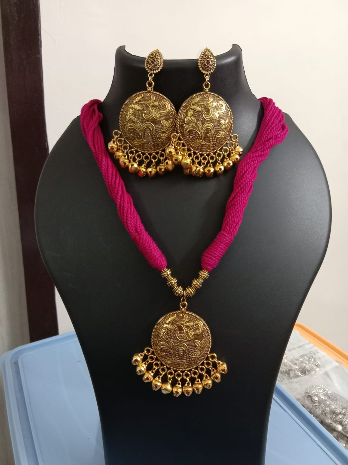 Red thread necklace with golden oxidised traditional pendant